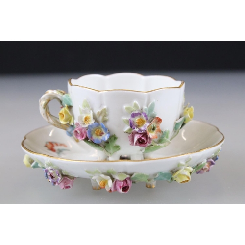 28 - Meissen Porcelain Cabinet Cup and Saucer, floral encrusted and painted with flowers, blue cross swor... 