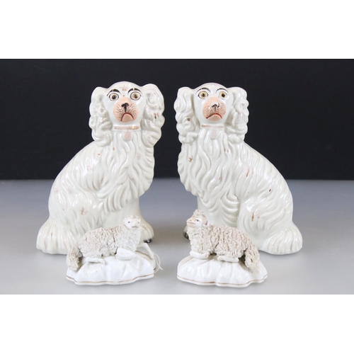 29 - Two antique Staffordshire spaniels, together with pair of similar 19th century sheep