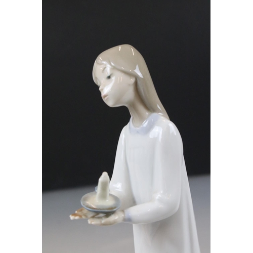 43 - Lladro Figurine of a Girl carrying a chamber stick, 21cm high