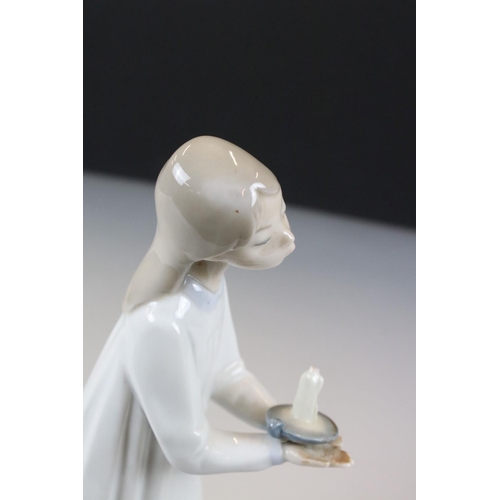 43 - Lladro Figurine of a Girl carrying a chamber stick, 21cm high