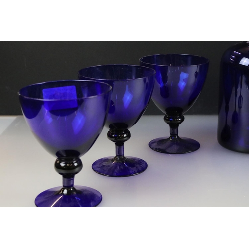 52 - Bristol Blue style Glass Carafe, 25cm high together with five matching Wine Glasses