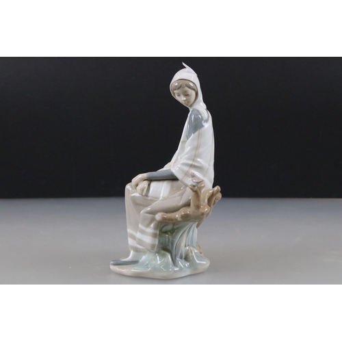 55 - Lladro Figurine of a Girl sat on a tree stump with picnic basket and bird, 26cm high