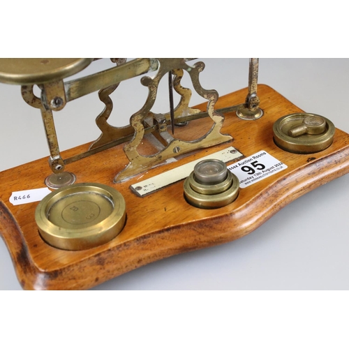 95 - Set of Victorian Brass Postal Scales with Six Weights on a Wooden Plinth Base, 25cm long