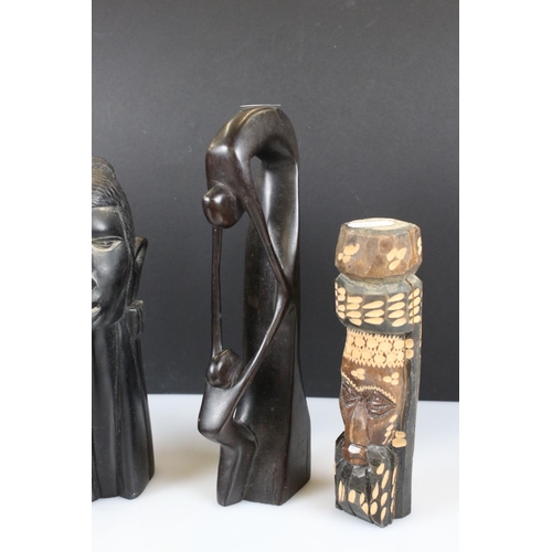 343 - A small collection of wooden and stone tribal carvings.