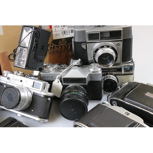 371 - A large collection of cameras to include Kodak, Zenit and Agfa examples