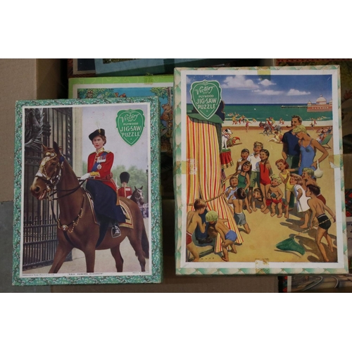 375 - A large collection of early to mid 20th century wooden Victory jigsaw puzzles.