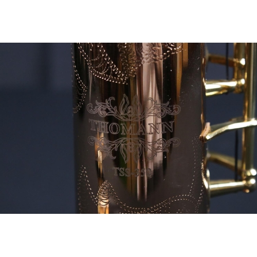 388 - A contemporary antique style Thomann TSS-350 soprano saxophone in fitted case.