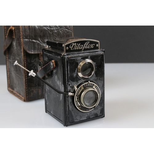 394 - A Yashica-Mat Copal MXV twin lens reflex camera together with a Vitaflex twin lens reflex camera.