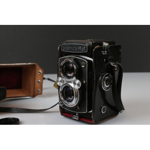 394 - A Yashica-Mat Copal MXV twin lens reflex camera together with a Vitaflex twin lens reflex camera.