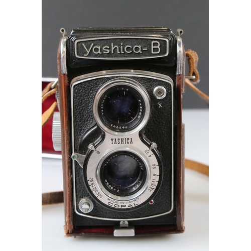 395 - A Yashica Lynx 5000 SLR camera together with a Yashica B twin lens reflex camera.