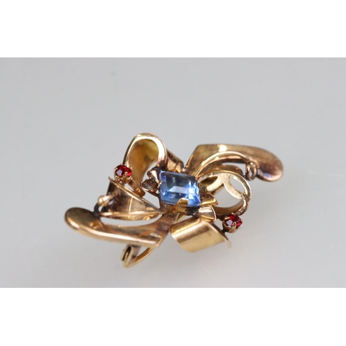 209A - An early 20th century ladies brooch, rose gold in colour and set with blue & red stones, marked 800 ... 