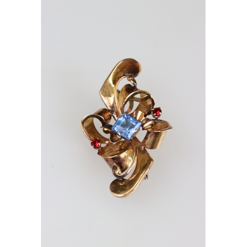 209A - An early 20th century ladies brooch, rose gold in colour and set with blue & red stones, marked 800 ... 