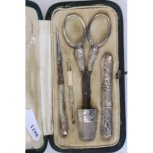 234 - A decorative white metal pocket sewing set to include thimble, scissors, needle case...etc in origin... 