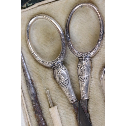 234 - A decorative white metal pocket sewing set to include thimble, scissors, needle case...etc in origin... 