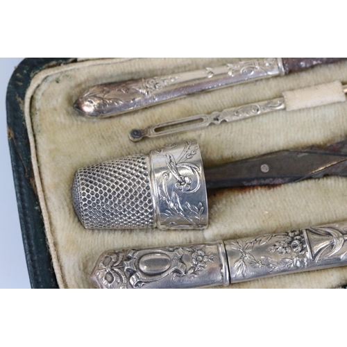 234 - A decorative white metal pocket sewing set to include thimble, scissors, needle case...etc in origin... 