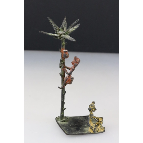 240 - A cast metal palm tree and figural ornament.