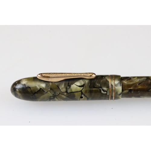 243 - An early 20th century Conklin fountain pen with green marbled case and 14ct gold nib together with a... 