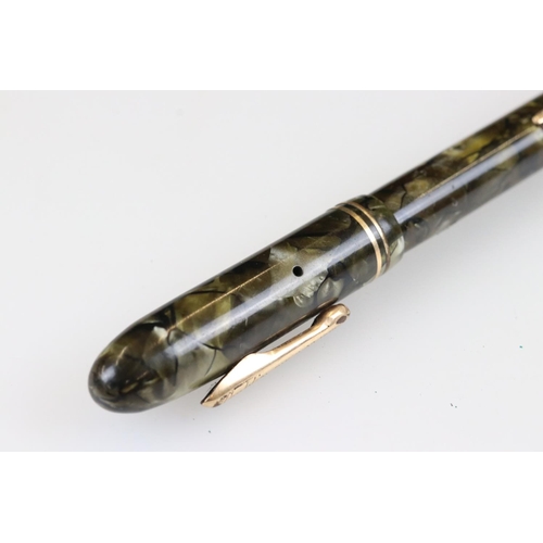 243 - An early 20th century Conklin fountain pen with green marbled case and 14ct gold nib together with a... 