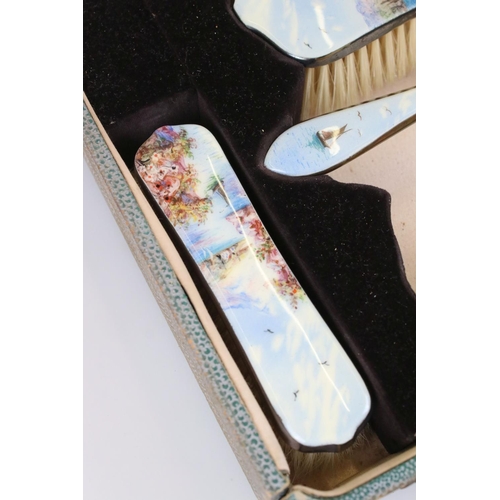 254 - A mid 20th century silver plated brush and mirror vanity set with detailed enamel decoration and con... 