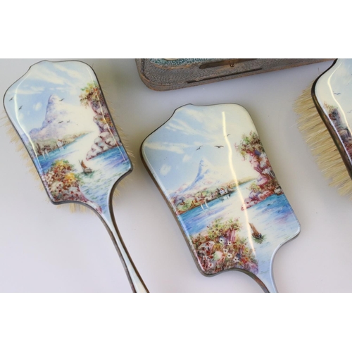 254 - A mid 20th century silver plated brush and mirror vanity set with detailed enamel decoration and con... 