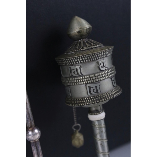 266 - A white metal Tibetan prayer wheel together with a white metal tea infuser.