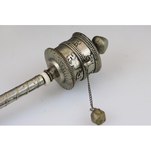 266 - A white metal Tibetan prayer wheel together with a white metal tea infuser.