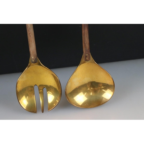 268 - A pair of brass salad servers with wooden handles.