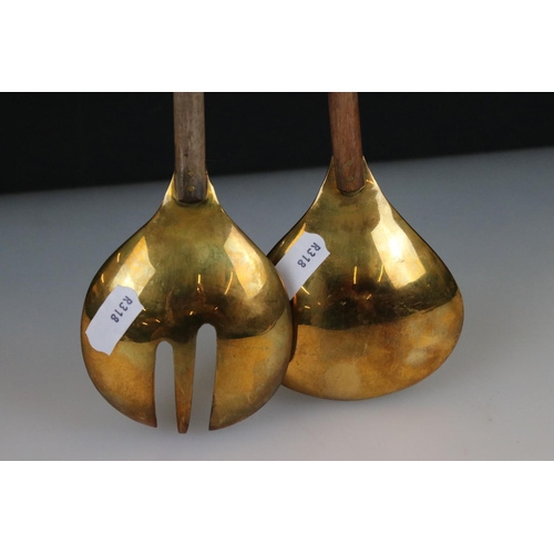 268 - A pair of brass salad servers with wooden handles.