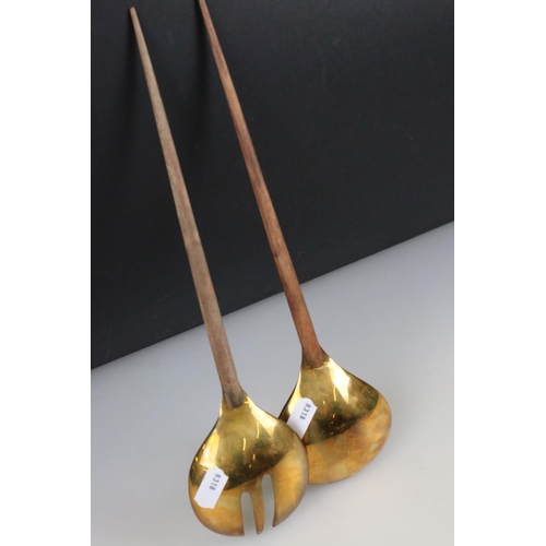 268 - A pair of brass salad servers with wooden handles.