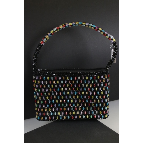 275 - A ladies beaded handbag together with a large ladies costume jewellery necklace.