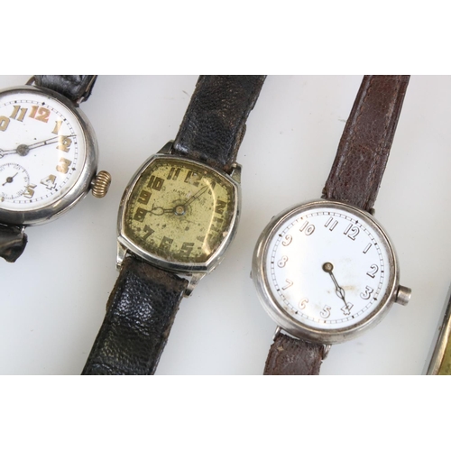 300 - Four military watches to include silver trench watches, WW2 Hamilton etc