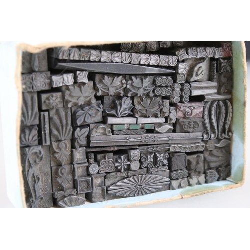 308 - A collection of metal ink stamps with patterned decoration.