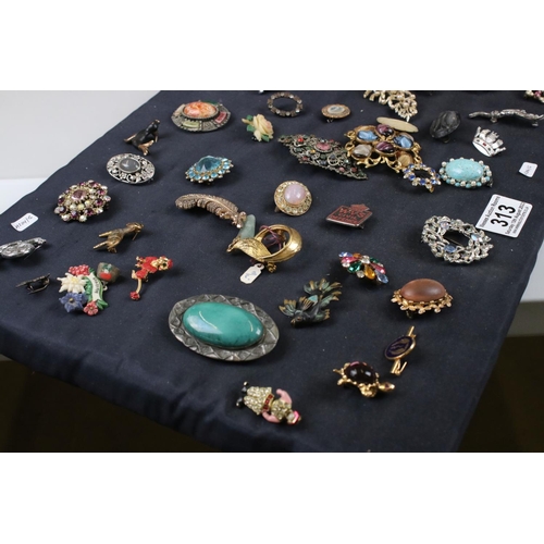 313 - Collection of approx. 73 brooches on a cushioned board, to include silver, micro mosaic & others