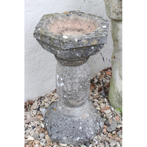 516 - A reconstituted stone garden ornament together with a stone bird bath