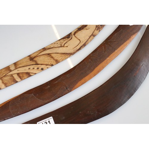 131 - A collection of three Australian carved wooden boomerangs.