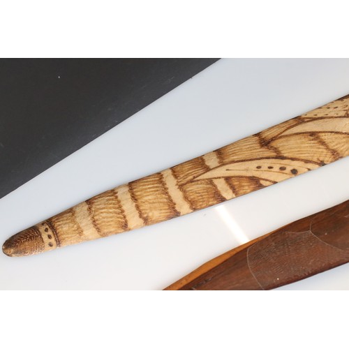 131 - A collection of three Australian carved wooden boomerangs.