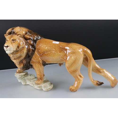 4 - Goebel Lion stood on a rocky outcrop, model 36 019 25, 47cm long together with a Novelty ' Bunny ' T... 