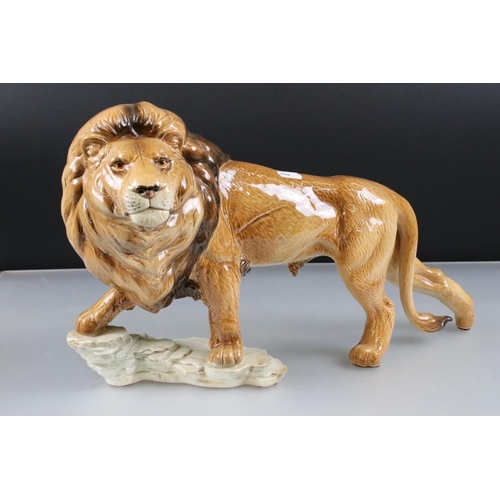 4 - Goebel Lion stood on a rocky outcrop, model 36 019 25, 47cm long together with a Novelty ' Bunny ' T... 