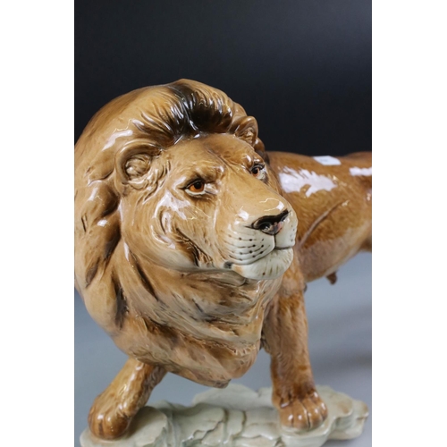 4 - Goebel Lion stood on a rocky outcrop, model 36 019 25, 47cm long together with a Novelty ' Bunny ' T... 