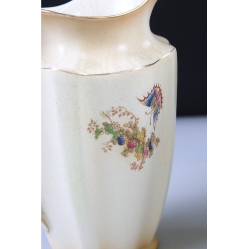48 - Set of Three Crown Ducal Graduating Blush Ivory Jugs decorated with exotic birds, largest 22cm