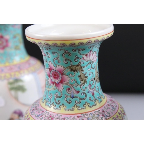 54 - Two Pairs of 20th century Chinese Famille Rose Vases, both decorated with figures and with red chara... 