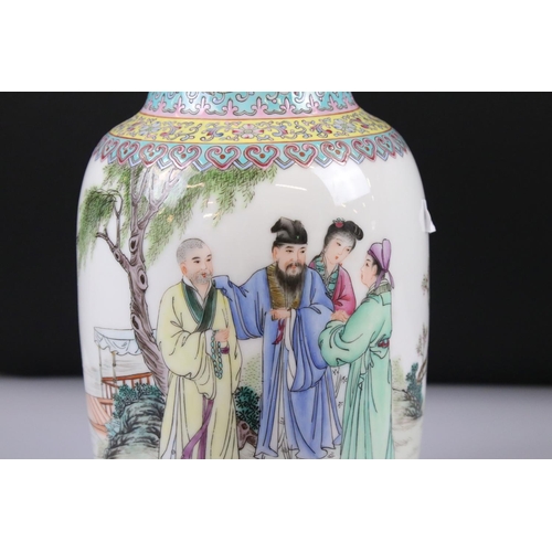 54 - Two Pairs of 20th century Chinese Famille Rose Vases, both decorated with figures and with red chara... 