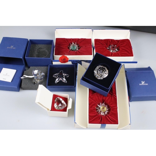57 - Six Boxed Swarovski items including Spiral Shell, Starfish, Christmas Hear Ornament, Heart Two Daisi... 