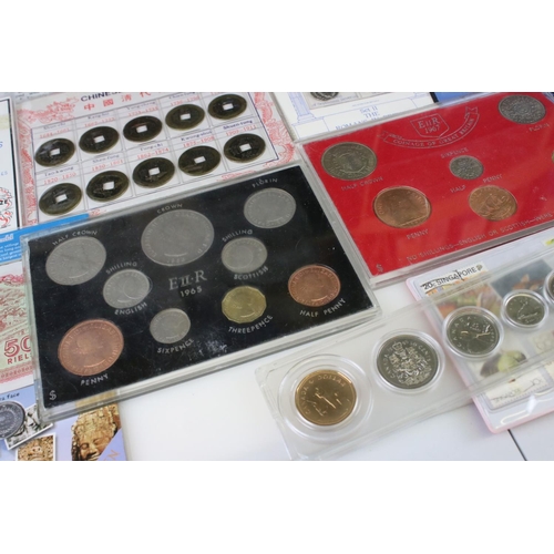 194 - A collection of mixed British and Foreign coins to include proof sets, commemorative coins...etc.