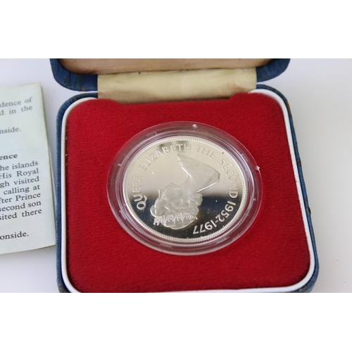 64 - A collection of three cased silver proof coins with COA's to include a Royal Mint 1977 silver proof ... 