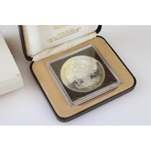 64 - A collection of three cased silver proof coins with COA's to include a Royal Mint 1977 silver proof ... 