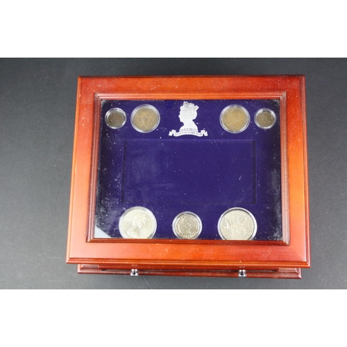 208 - A Danbury Mint 'Her Majesty Queen Elizabeth II' coin and banknote set mounted within wood and glass ... 