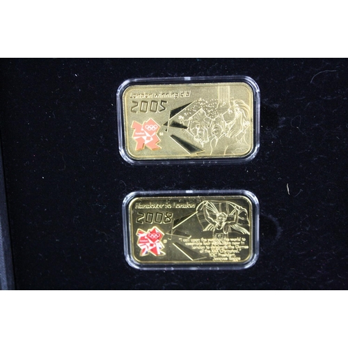 44 - A London Mint Office London 2012 Olympics coin and silver layered ingot set together with a London M... 