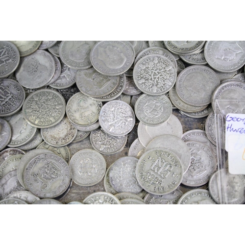 60 - A collection of British sixpence and threepence silver coins to include King George V and King Georg... 