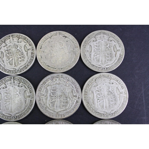 66 - A collection of twelve British King George V pre 1947 silver half crown coins.